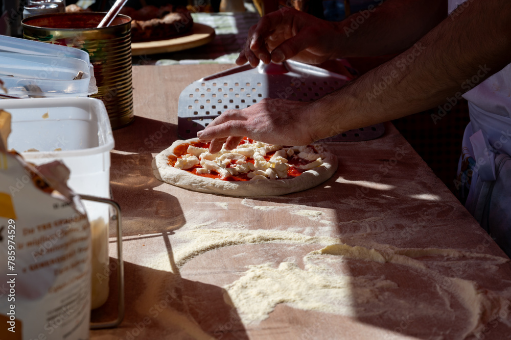 Making of fresh Italian pizza, street food, Portobello road food market on Saturday, London, UK