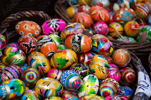 Decorated Easter eggs on sale at the Easter fair bazaar stall, traditional market stand in Poland. Collection of colourful painted Paschal eggs. Wooden pisanki egg decorations.