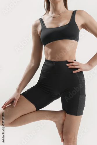 Young woman practicing stretching yoga positions, wellbeing and self care concept
