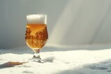 Glass of beer in the snow on a white background with copy space