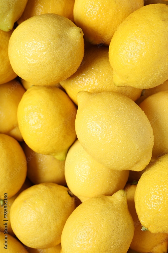 Fresh lemons with water drops as background, closeup Fresh lemons with water drops as background, closeup