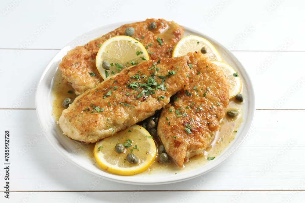 Delicious chicken piccata on white wooden table Delicious chicken piccata on white wooden table