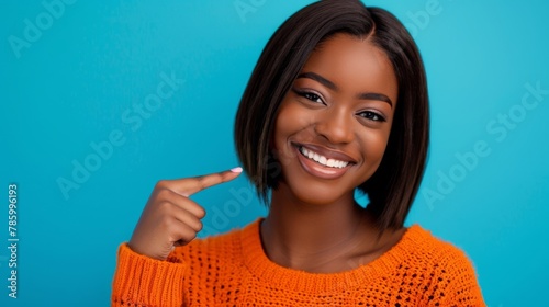 Woman Pointing to Her Smile photo