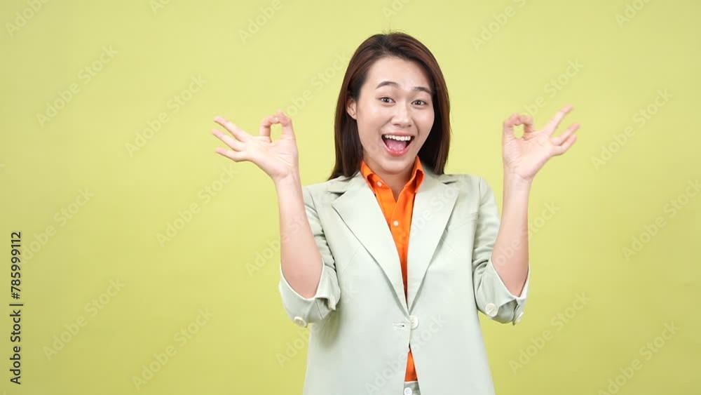 Young Asian businesswoman on green background Young Asian businesswoman on green background