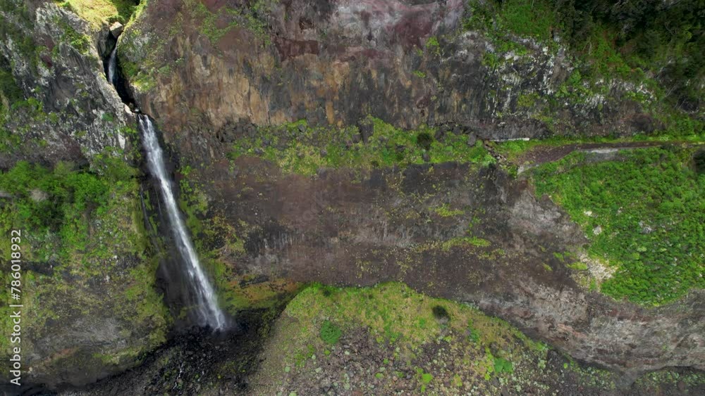 Veu da Noiva Viewpoint Waterfall Flowing From A Cliff In Madeira Island, Portugal. - aerial shot Veu da Noiva Viewpoint Waterfall Flowing From A Cliff In Madeira Island, Portugal. - aerial shot