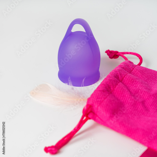 Ease and Airiness in Storage: Purple Menstrual Cup, Pouch, and Light Feather