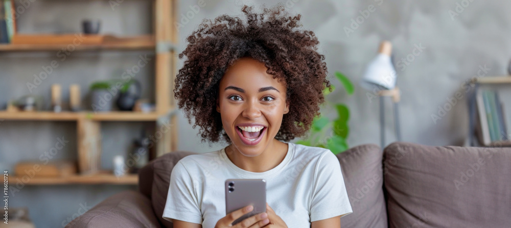 A woman with curly hair is sitting on a couch A woman with curly hair is sitting on a couch