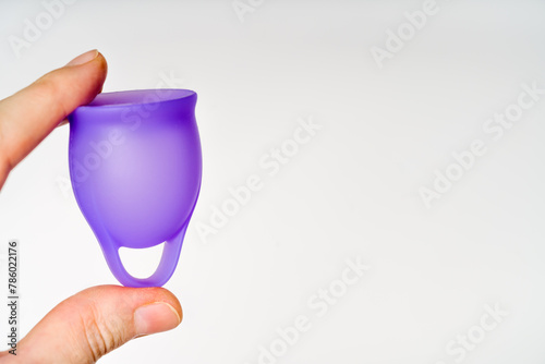Female Hands with Violet Menstrual Cup: Blank Area on White Backdrop