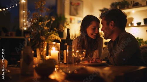A couple having a romantic candlelit dinner at home.  photo