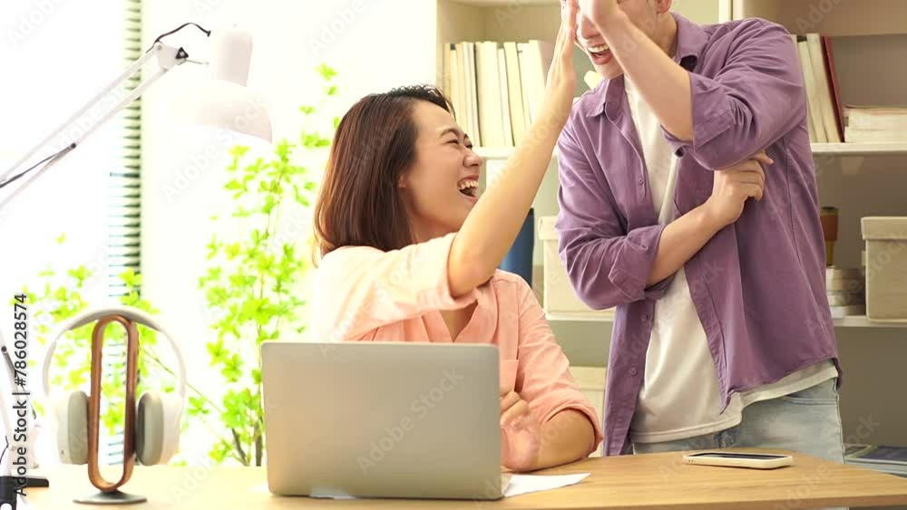 Two young Asian businesspeople working
