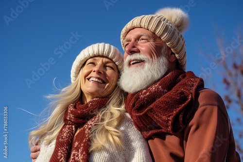 A couple wearing winter gear and smiling at the camera