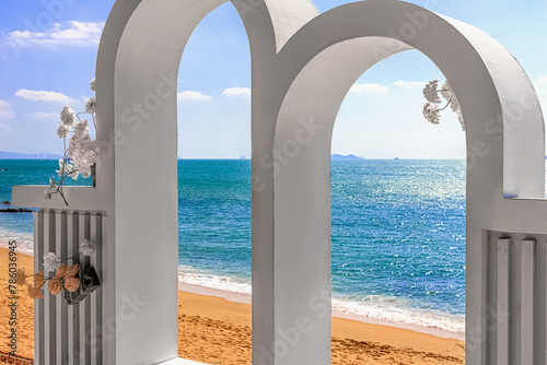 View of the beautiful white wedding arch  which is located on the shore of the blue sea. Sanya China
