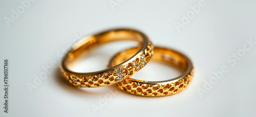 Two gold wedding rings with diamonds on them