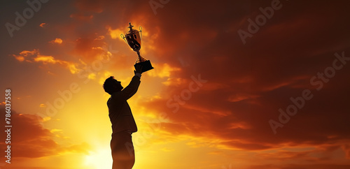 man holding up a trophy against sunset sky background, panoramic layout. Generative Ai
