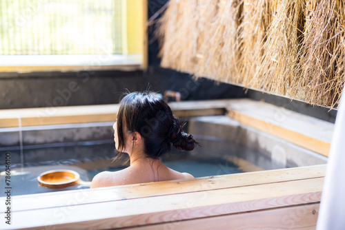Asian Young woman relaxing in hot spring