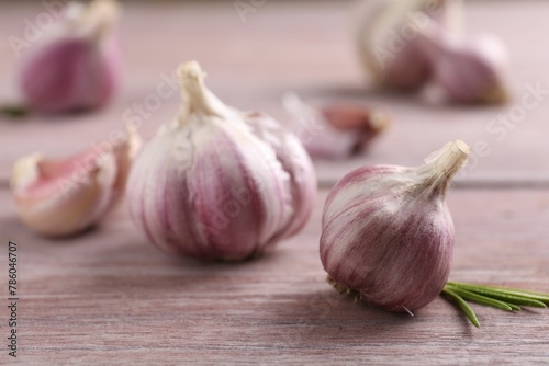 Bulbs of fresh garlic on wooden table, selective focus