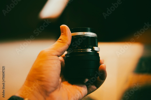 Fototapeta Old vintage camera,Close-up of hand holding camera lens against sky,Close-up of hand holding camera outdoors