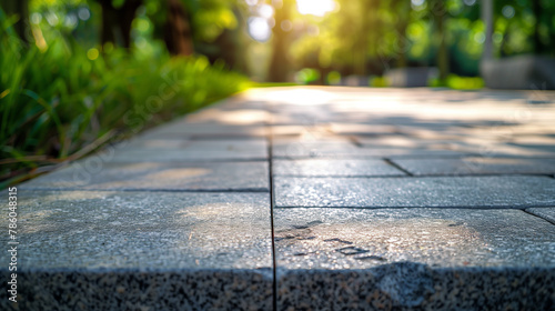 Stone walking jogging path in nature park, green summer environment shining with the natural rays of morning sunshine, relax and calm morning walk