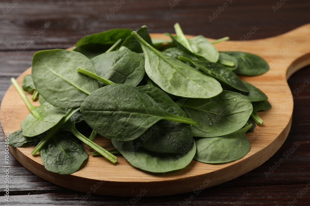 Bowl with fresh spinach leaves on wooden table, closeup Bowl with fresh spinach leaves on wooden table, closeup