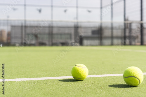 Bright greenish, yellow tennis ball on freshly painted court © Angelov