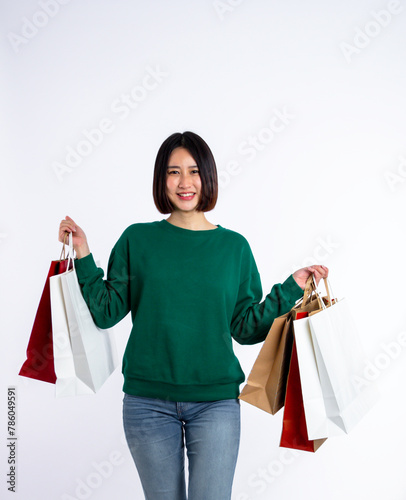 Young woman asian wearing green shirt of smiling face in shopping solated on white background, she is smiling lifesty and looking at camera, portrait young woman shopping, lifestyle concept.