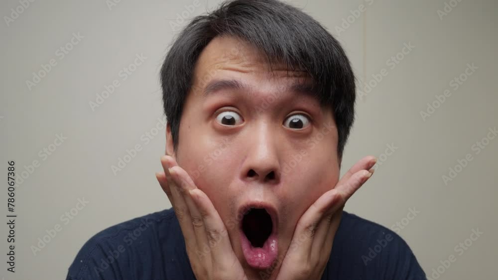 Young Chinese man astounded and shocked. Facial expressions and emotions