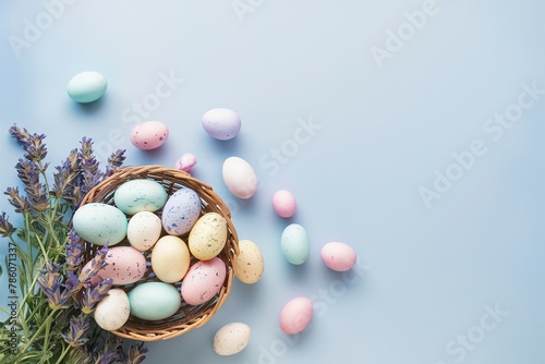 colorful Easter eggs in a basket on a blue background with lavender flowers