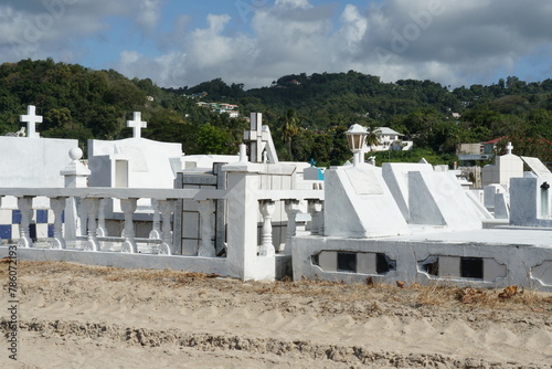 White graves and tombstones in a cemetery near the beach in Castries, Saint Lucia, one of the Caribbean islands.   