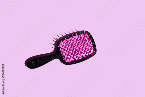 Vibrant Elegance top view of a hairbrush resting on a vibrant pink surface, adorned with a captivating lattice pattern in neon pink and deep black tones. fashion accessories