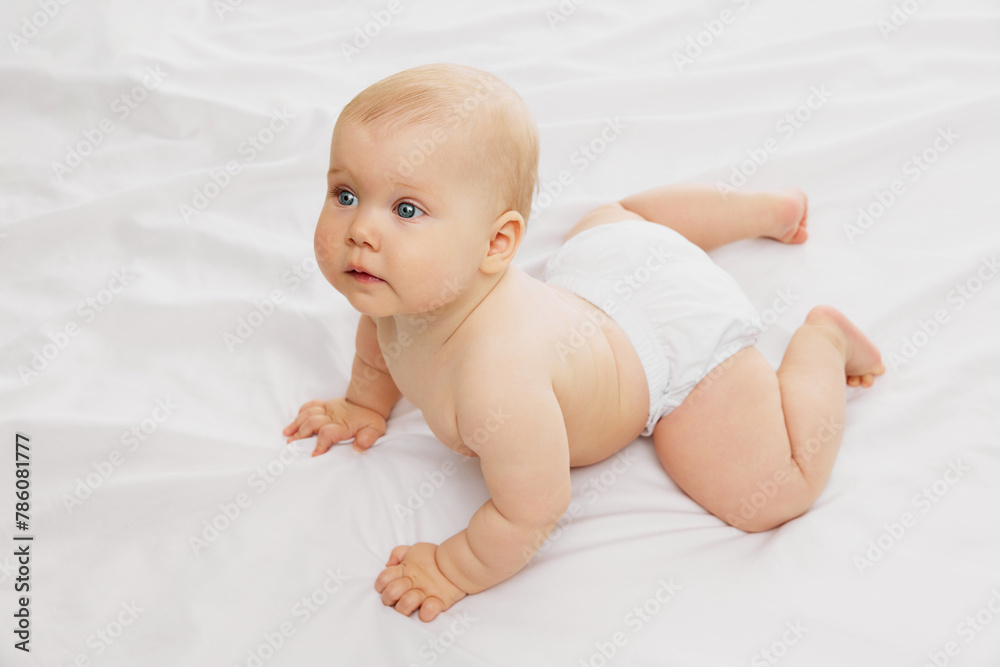 Serene, cute baby in diaper, rests on textured white fabric on bed embodying the calmness of early childhood. Concept of childhood, motherhood, life, birth. Copy space for ad Serene, cute baby in diaper, rests on textured white fabric on bed embodying the calmness of early childhood. Concept of childhood, motherhood, life, birth. Copy space for ad