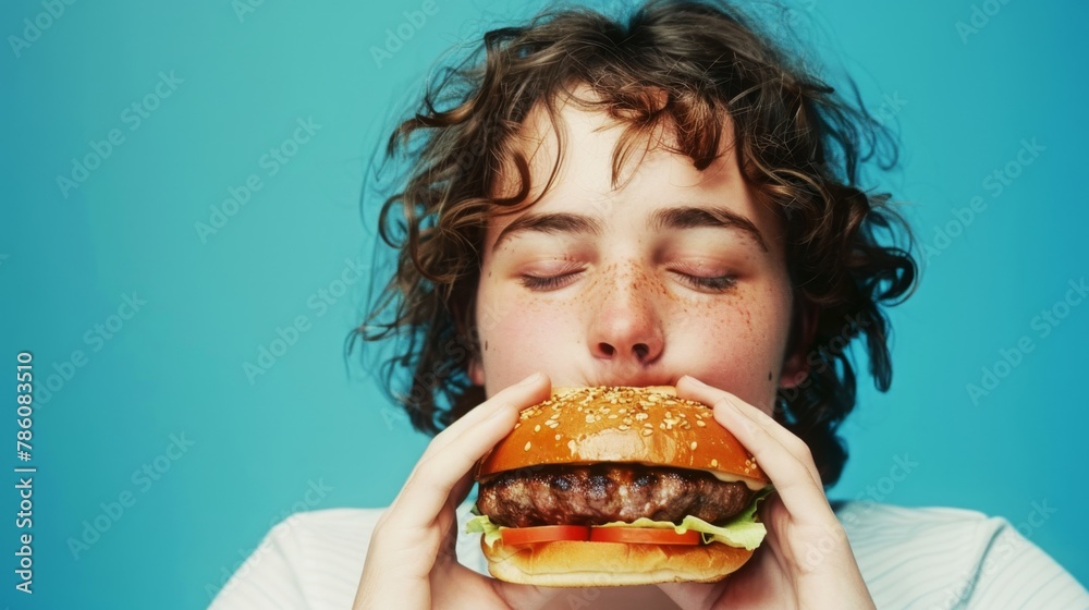 Ecstasy envelops as eyes shut, savoring each bite of the juicy burger, blissful taste buds dancing in delight against a serene blue backdrop.
