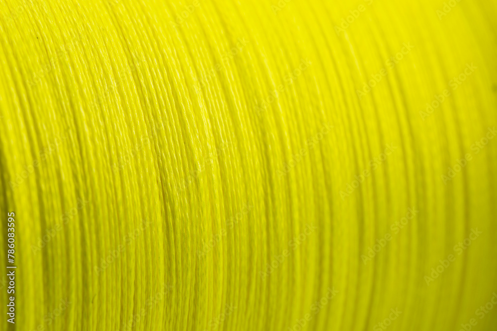 Yellow fishing braided line close up. Spool of green cord isolated. Spool of braided fishing line Yellow fishing braided line close up. Spool of green cord isolated. Spool of braided fishing line
