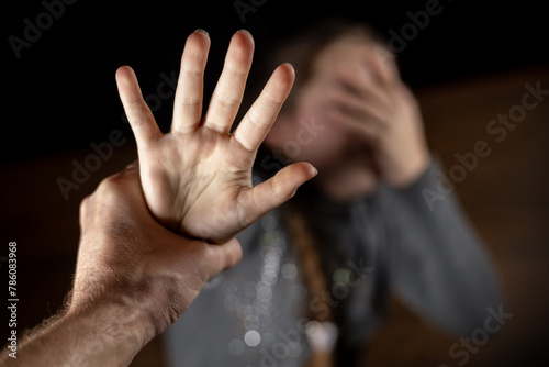 Crying teenage girl showing a stop sign with her hand
