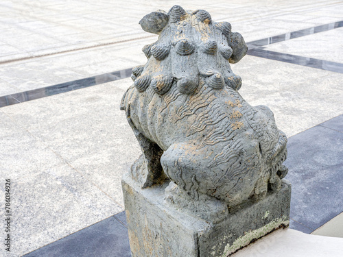Chinese or Japanese granite stone lion back view, display at public landscape