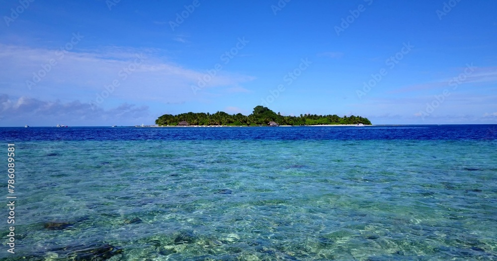 Beautiful tropical island with crystal water under a blue cloudy sky on a sunny day