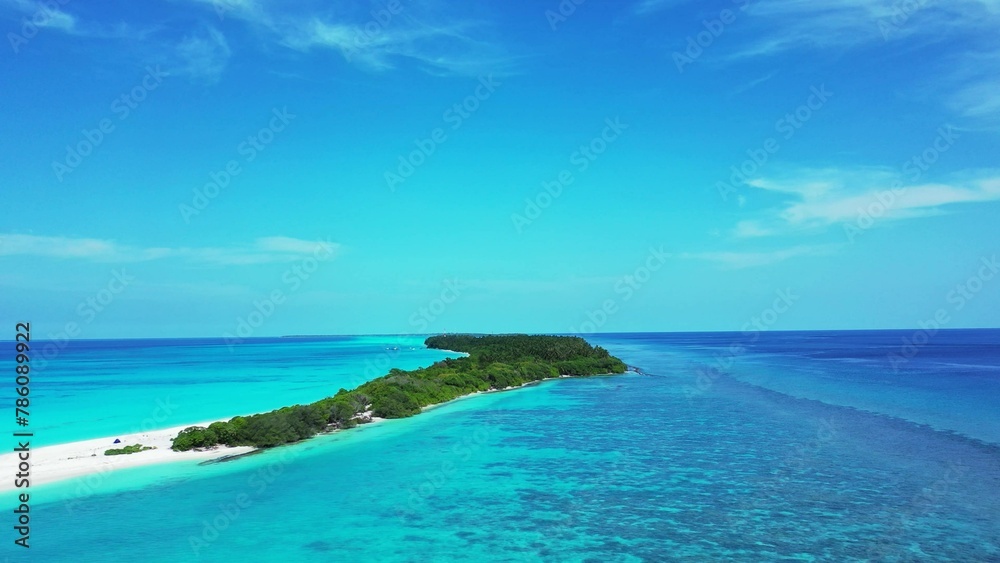 Aerial drone view of a beautiful tropical island under a blue cloudy sky on a sunny day