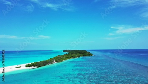 Aerial drone view of a beautiful tropical island under a blue cloudy sky on a sunny day
