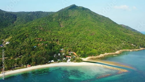 Aerial view of a city on an island in the middle of the blue calm sea on a sunny day