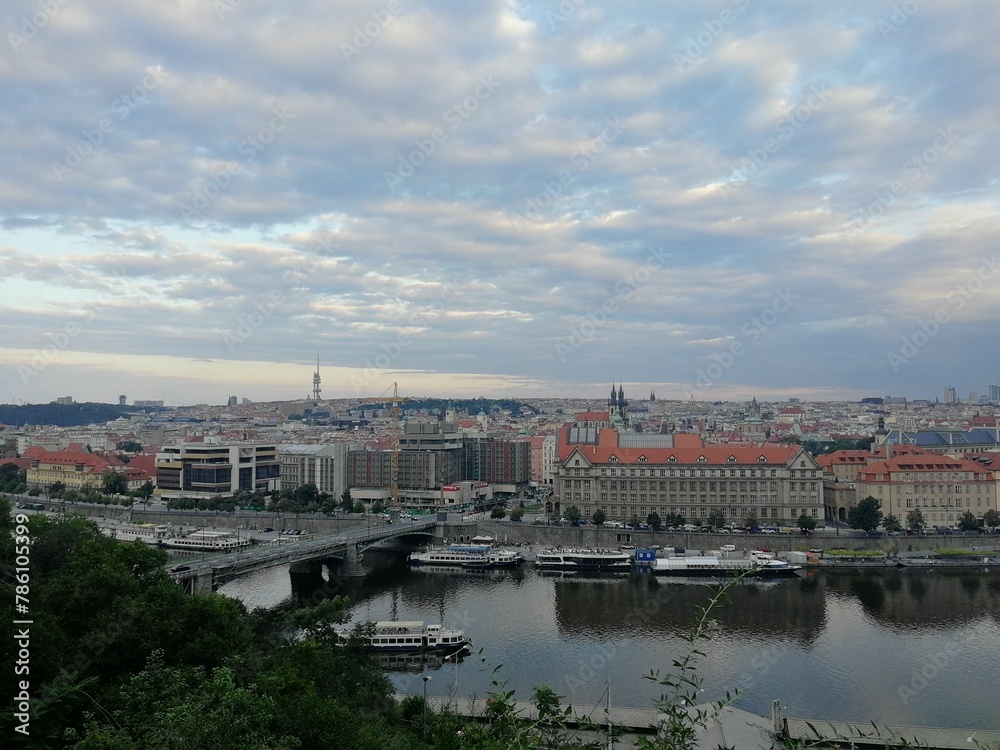 Aerial view of the skyline of Prague near the Vltava River under a bright sky