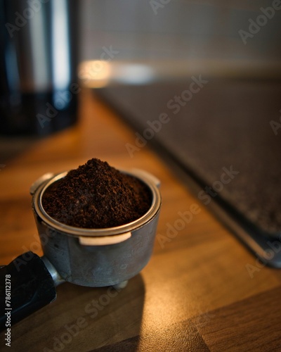 Vertical shot of fresh coffee in a portafilter photo