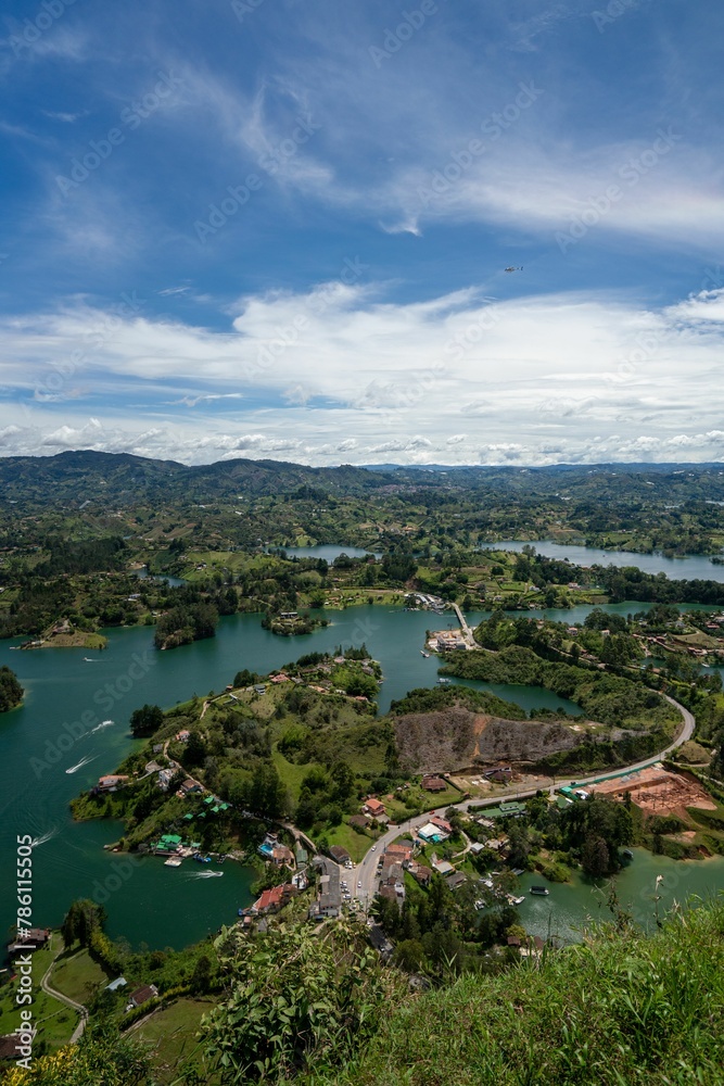 Vertical aerial view of a landscape with lakes and lush vegetation in Guatape