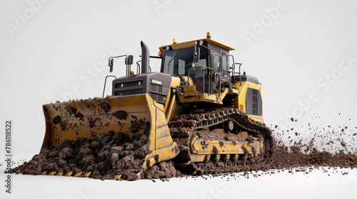 A yellow and black bulldozer is in a muddy field