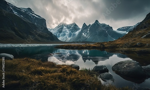an image of the valley reflected in the water with rocks and grass on the ground