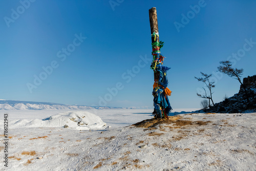 Lake Baikal in winter. Beautiful rocky island on a background of blue sky and ice.