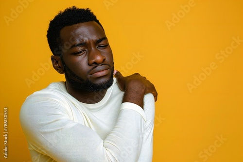 African man scratching itchy skin with black hand photo