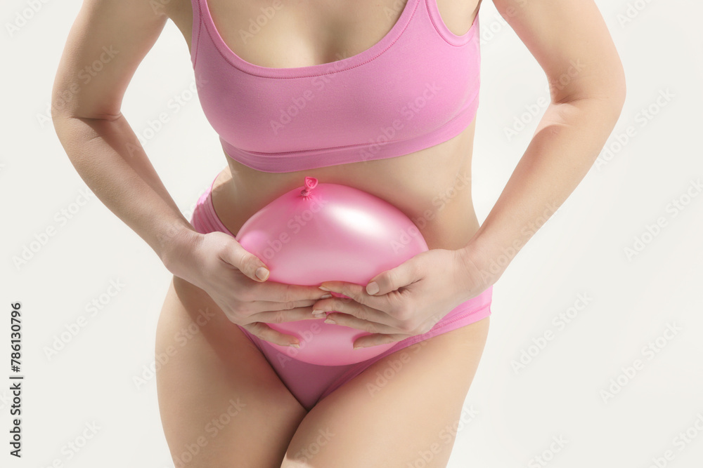 Ταπετσαρία Young woman holding balloon as a sign of an stomach inflation, bloating and mens