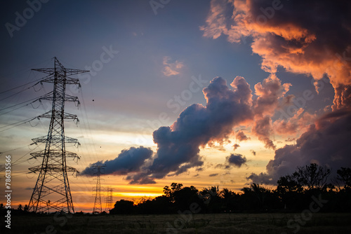 High voltage electricity tower sky sunset landscape, industrial background.