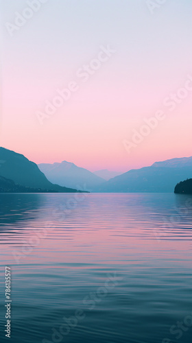 A calm lake reflects the view of a pink and blue sky