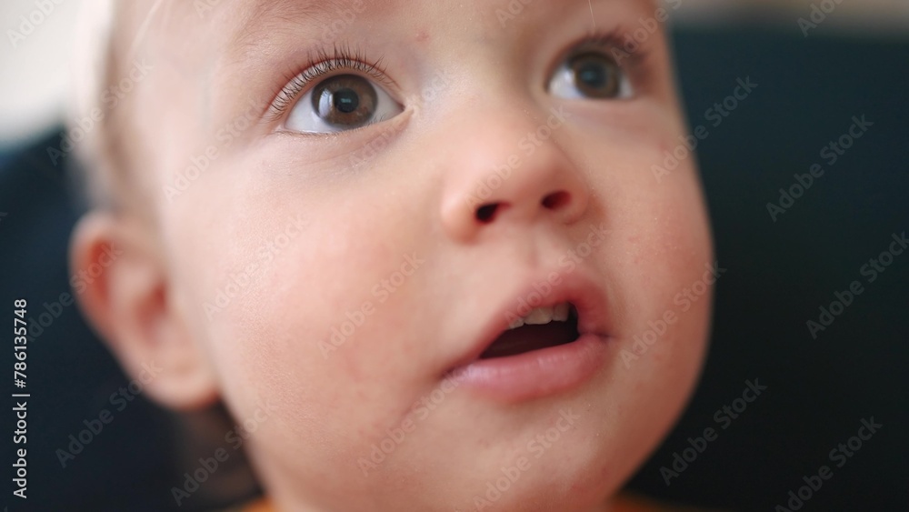 baby portrait close-up looking at the camera. happy family kid dream concept. baby blond indoors at home looking at the camera. lifestyle child son smiling sitting on the sofa close-up baby portrait close-up looking at the camera. happy family kid dream concept. baby blond indoors at home looking at the camera. lifestyle child son smiling sitting on the sofa close-up