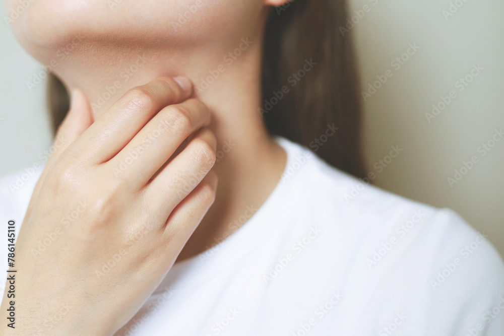 sore throat pain. Closeup of young woman sick holding her inflamed throat using hands to touch the ill neck sore throat pain. Closeup of young woman sick holding her inflamed throat using hands to touch the ill neck